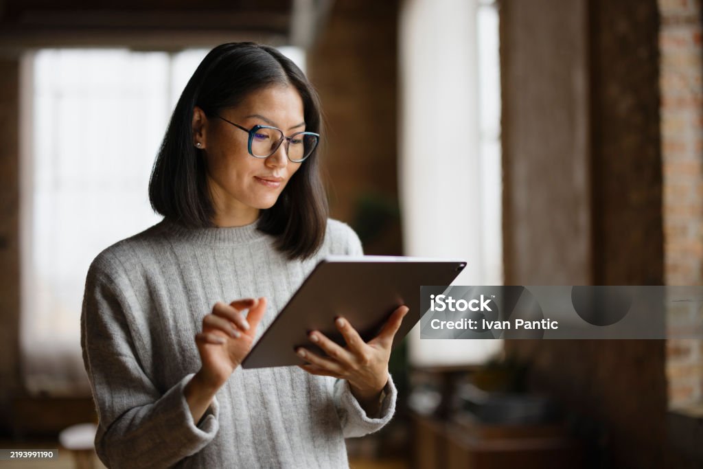 Professional reviewing information on a tablet.